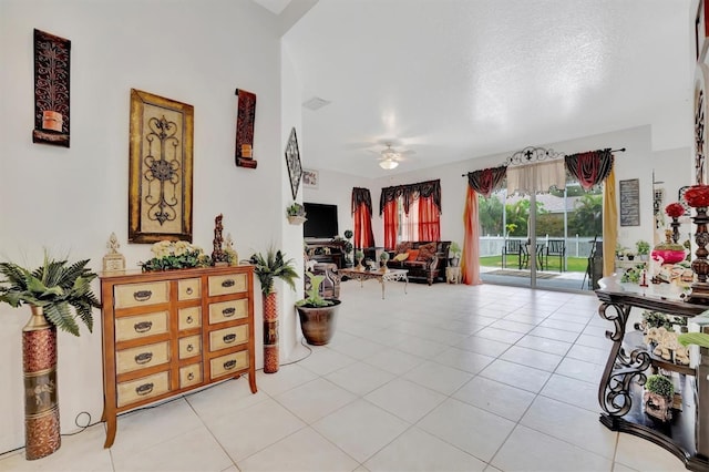 hallway featuring light tile patterned floors and a textured ceiling