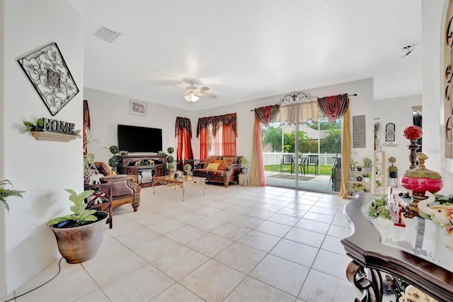 tiled living room with ceiling fan