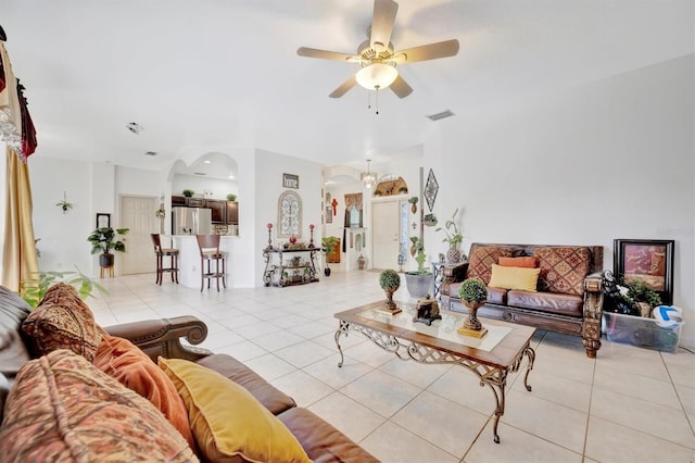 living room featuring light tile patterned floors and ceiling fan