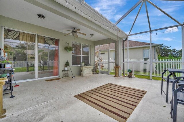 view of patio with ceiling fan and a lanai