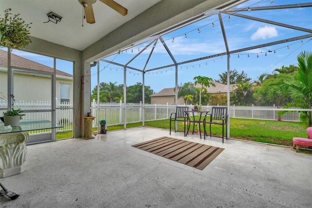 unfurnished sunroom featuring ceiling fan