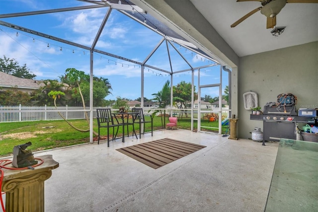 view of patio / terrace featuring ceiling fan and a lanai