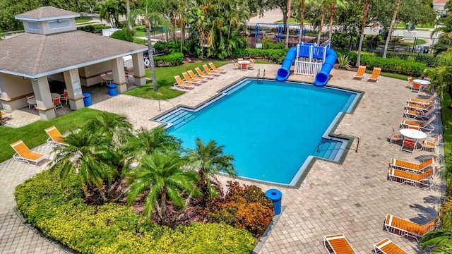 view of swimming pool featuring an outdoor bar and a patio