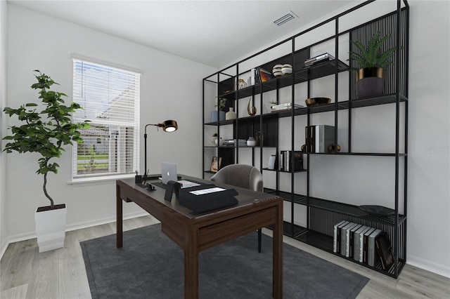 office area featuring visible vents, baseboards, and wood finished floors