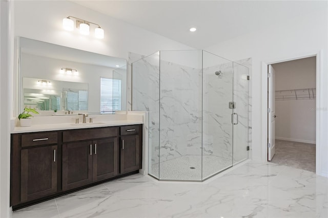 bathroom with a marble finish shower, marble finish floor, a spacious closet, vanity, and recessed lighting