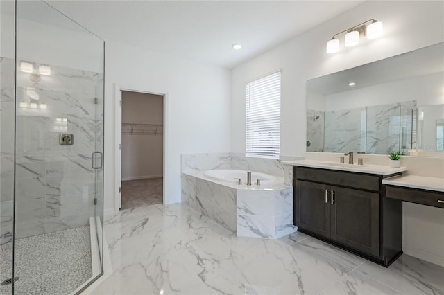 bathroom with a marble finish shower, marble finish floor, a garden tub, a walk in closet, and vanity