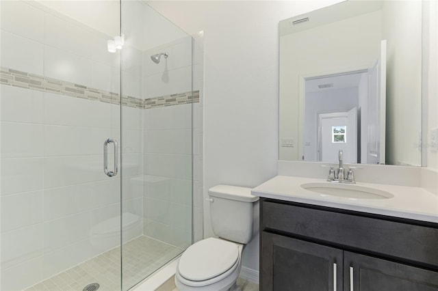 bathroom featuring visible vents, a shower stall, toilet, and vanity