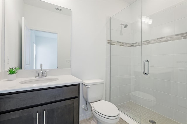 bathroom featuring visible vents, a shower stall, toilet, and vanity