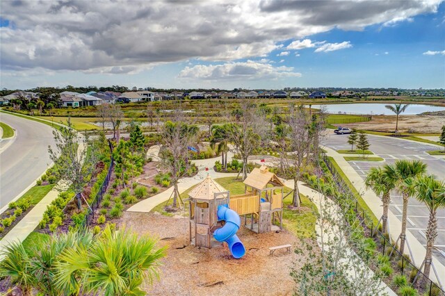 birds eye view of property featuring a water view and a residential view