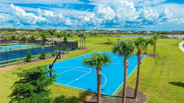 view of sport court with a tennis court, community basketball court, a lawn, and fence