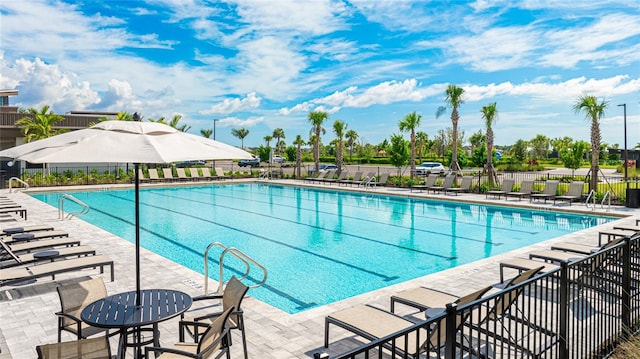 pool featuring a patio area and fence