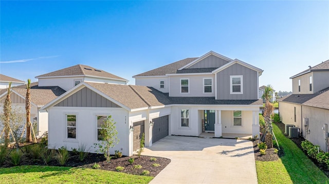 view of front of home featuring a garage, central air condition unit, board and batten siding, and concrete driveway