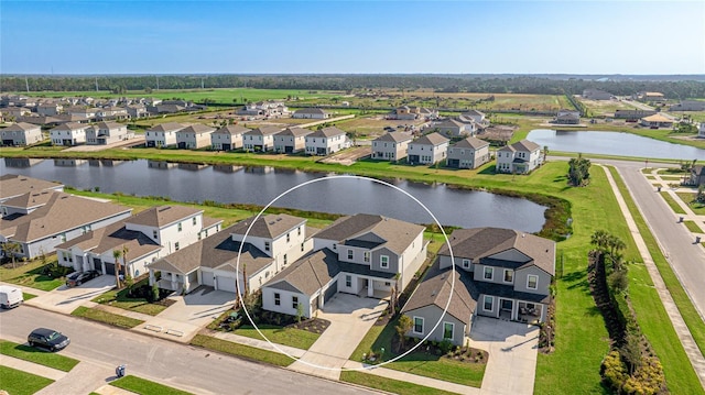 birds eye view of property with a water view and a residential view