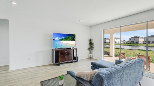 living room featuring recessed lighting, baseboards, and wood finished floors