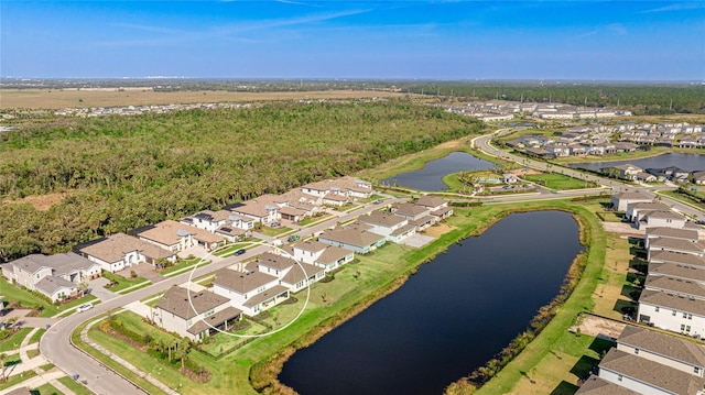 drone / aerial view with a water view and a residential view