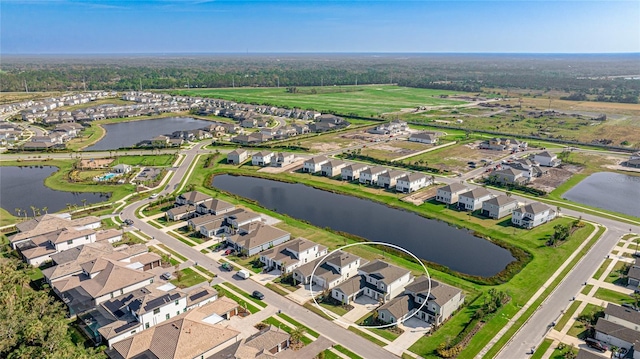 birds eye view of property with a residential view and a water view