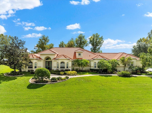 mediterranean / spanish-style home featuring a front yard