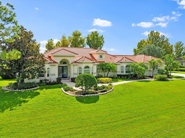 mediterranean / spanish-style house with a front yard