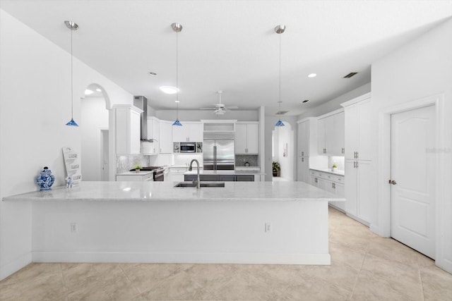 kitchen with pendant lighting, stainless steel appliances, and white cabinetry