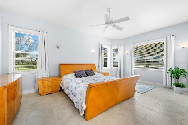 bedroom featuring light tile patterned floors and ceiling fan