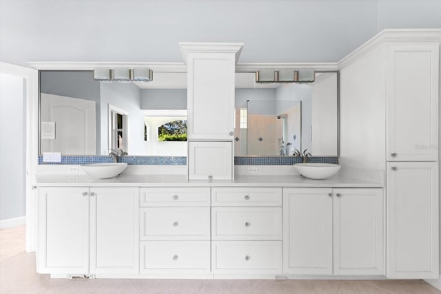 bathroom with a shower, vanity, and tile patterned floors