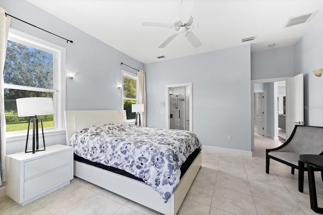 tiled bedroom with connected bathroom and ceiling fan