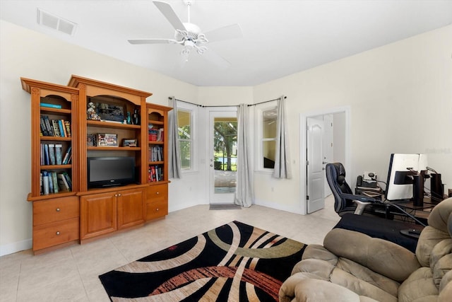 living room featuring ceiling fan and light tile patterned flooring