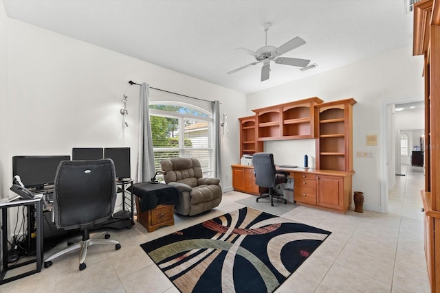 tiled home office featuring ceiling fan