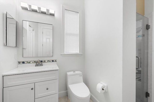 bathroom with vanity, toilet, and a shower with shower door