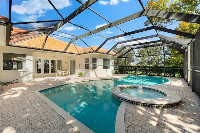 view of pool featuring glass enclosure, ceiling fan, an in ground hot tub, and a patio