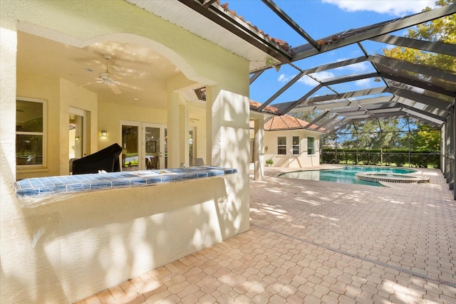 view of pool with ceiling fan, french doors, a lanai, an in ground hot tub, and a patio