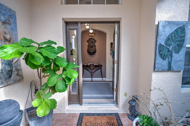 view of exterior entry with stucco siding