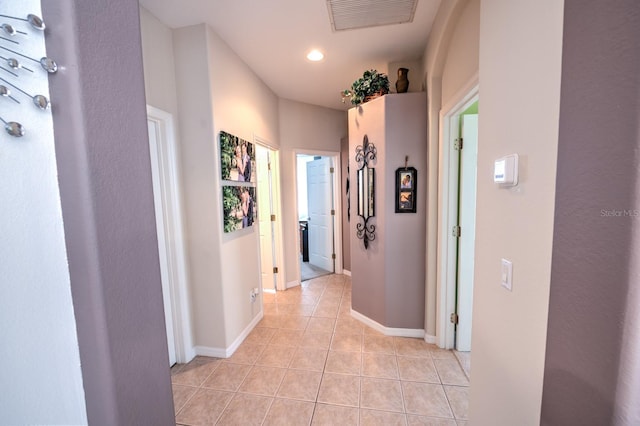 hall featuring recessed lighting, visible vents, baseboards, and light tile patterned flooring