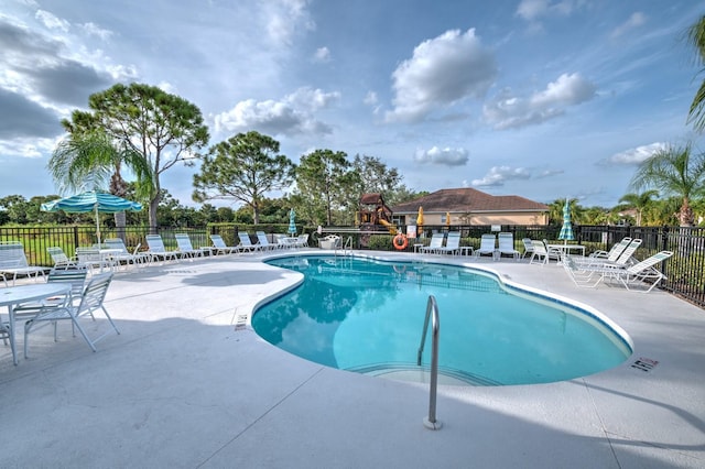 pool featuring a patio area and fence