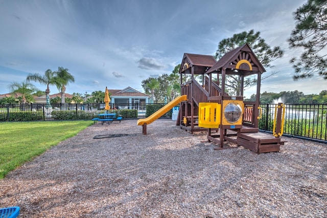 communal playground with fence and a lawn