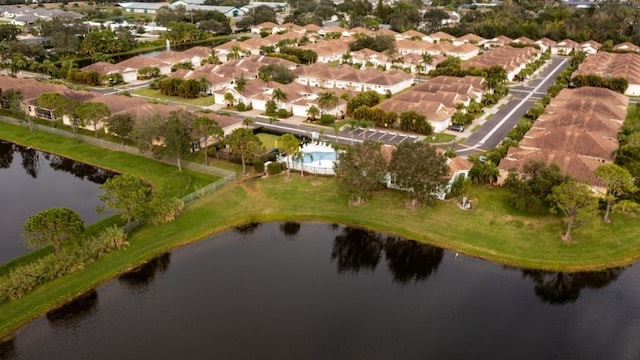 drone / aerial view with a water view and a residential view