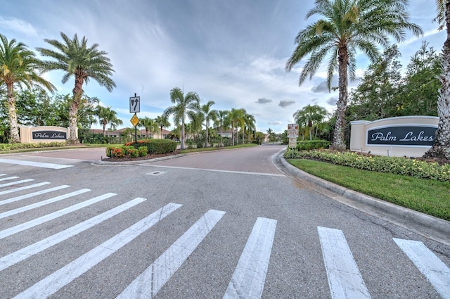 view of road featuring traffic signs and curbs