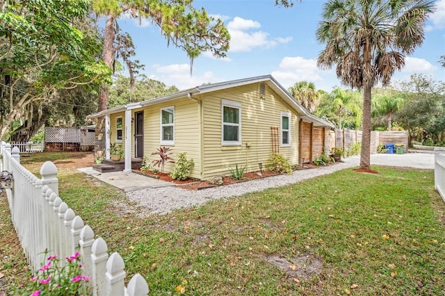 view of side of property with a lawn