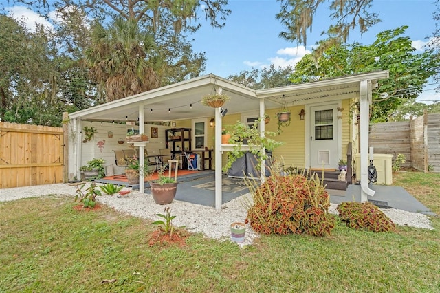 rear view of house featuring a lawn