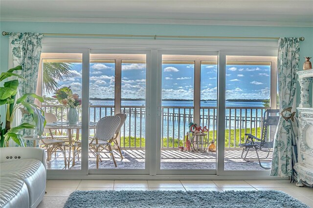 doorway with light tile patterned flooring and a water view