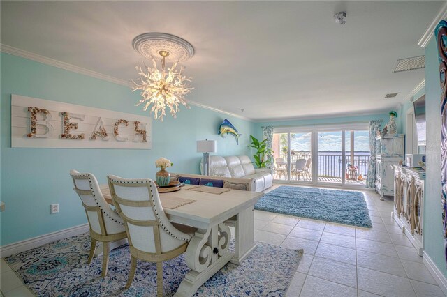 tiled dining room featuring ornamental molding and a chandelier