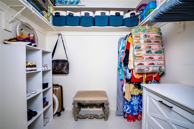 walk in closet featuring light tile patterned flooring