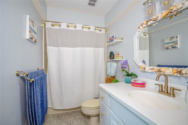 bathroom featuring tile patterned floors, toilet, vanity, and a shower with curtain