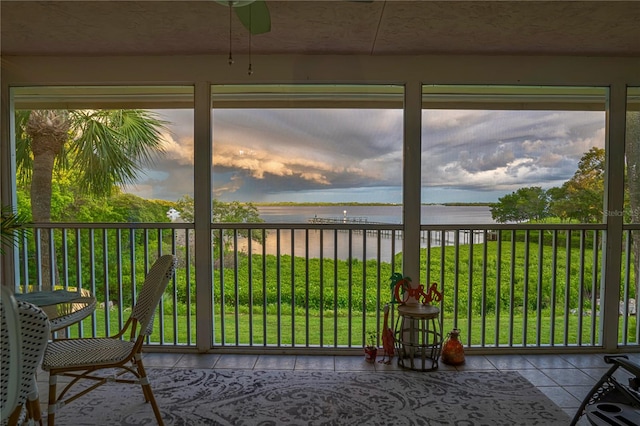 unfurnished sunroom featuring a water view