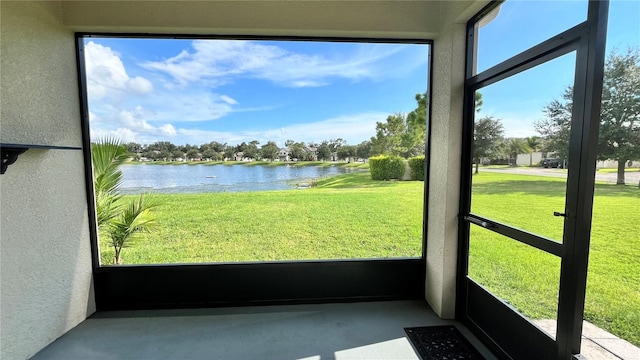 unfurnished sunroom featuring a water view