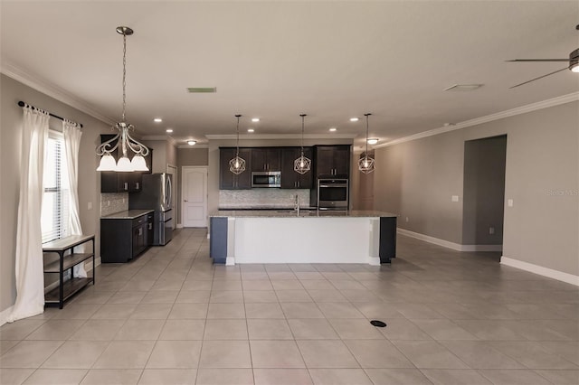 kitchen featuring stainless steel appliances, ornamental molding, a kitchen island with sink, and decorative backsplash