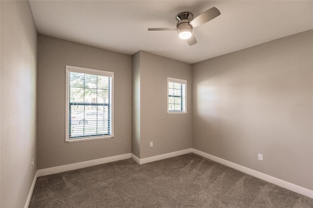 empty room with ceiling fan and carpet floors