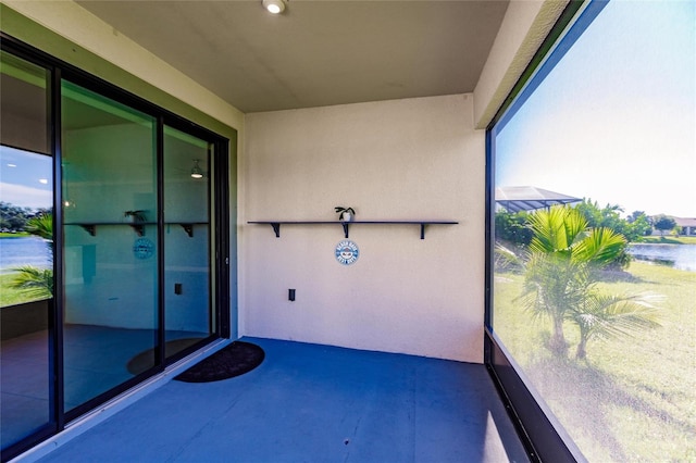 unfurnished sunroom with a water view