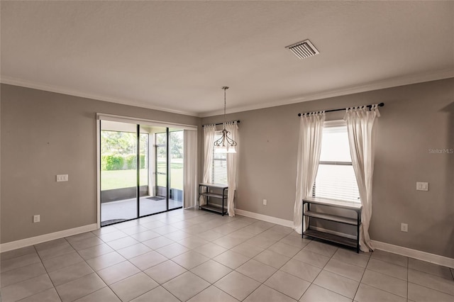 spare room featuring ornamental molding and plenty of natural light