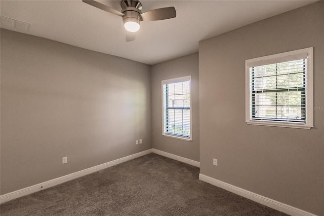 carpeted spare room featuring ceiling fan